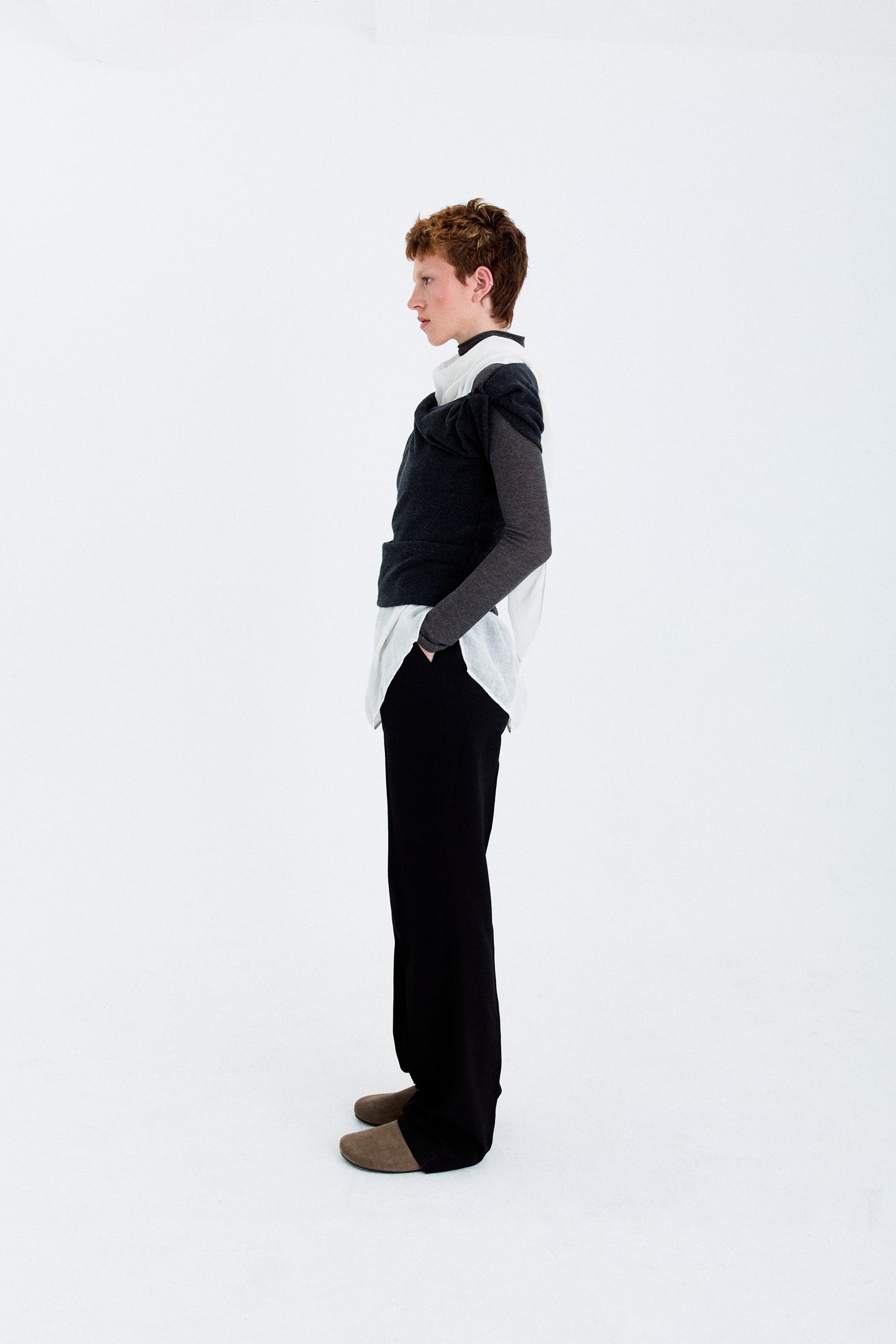 Angled model view in the YIBRI Fleece Asymmetrical Shoulder Twisted Top, showing the asymmetric sleeve line and soft fleece drape.