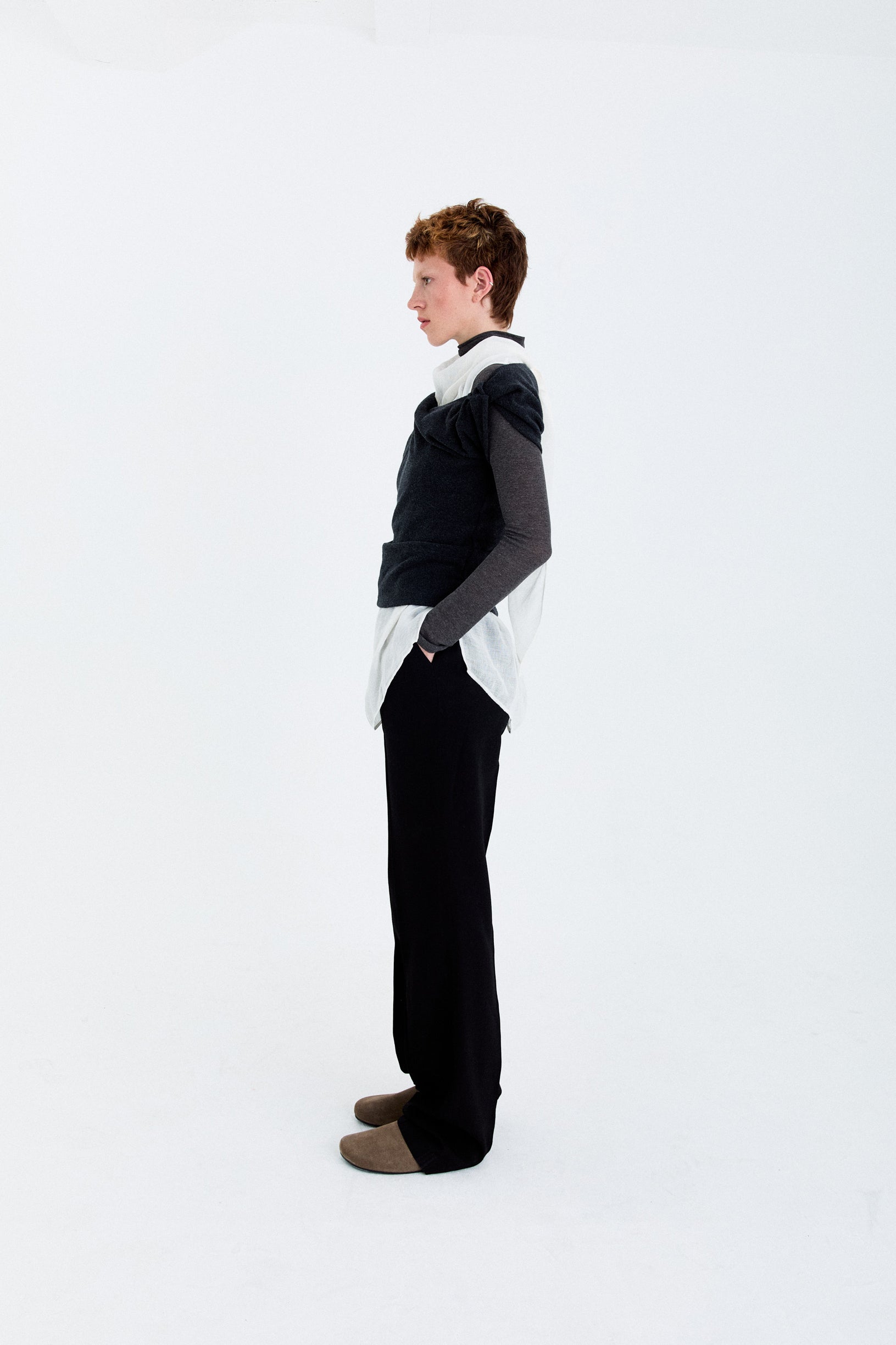 Angled model view in the YIBRI Fleece Asymmetrical Shoulder Twisted Top, showing the asymmetric sleeve line and soft fleece drape.