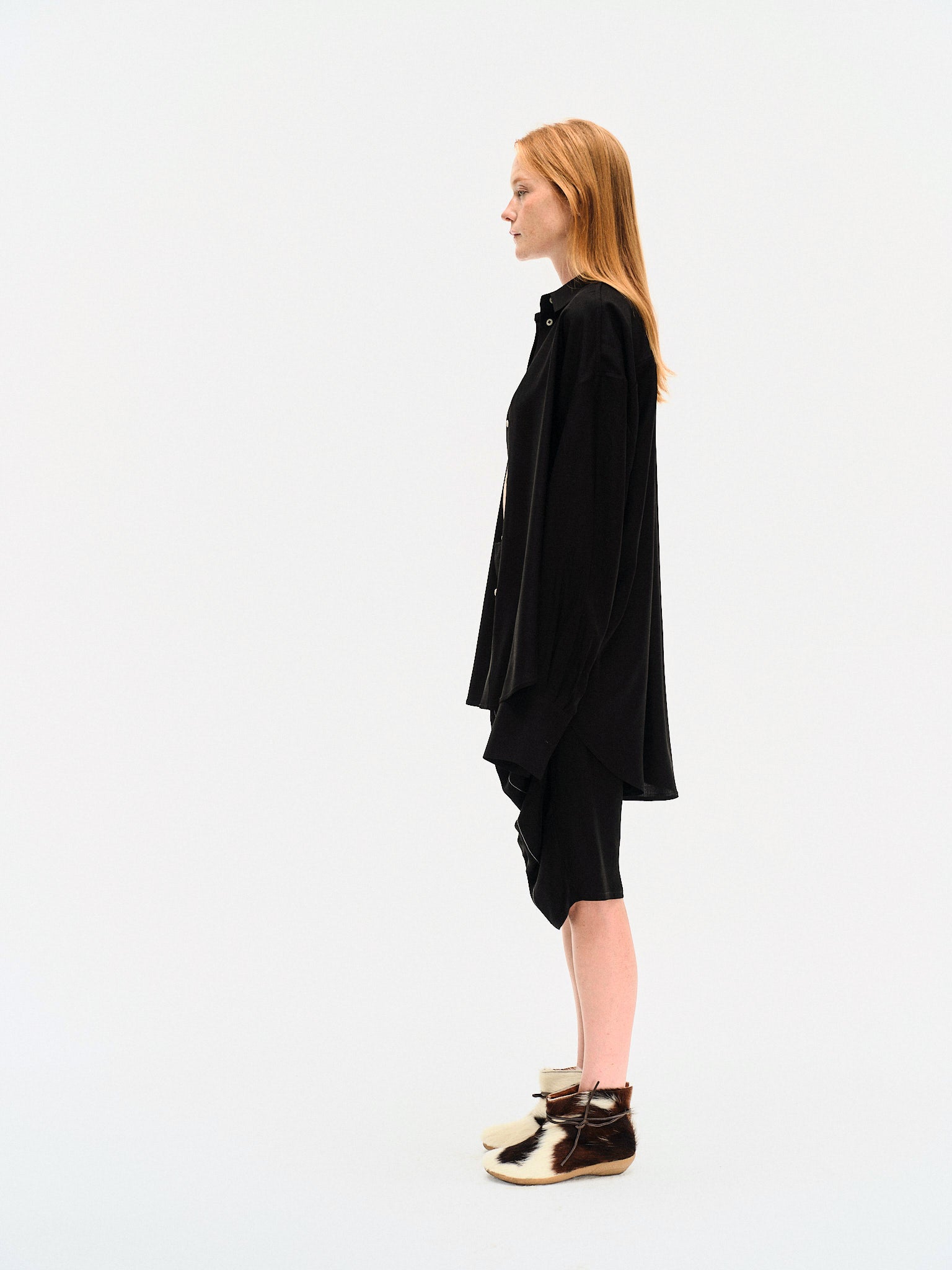 Back view on model of the YIBRI Black Japanese Viscose Button-Up Shirt showing extended drape and soft tailoring.