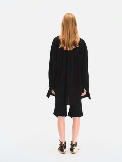 Side profile close-up of YIBRI Black Japanese Viscose Button-Up Shirt capturing the soft collar, fluid fabric and elegant fall.