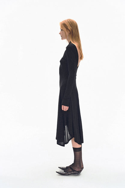 Model wearing YIBRI black long sleeve fitted knit dress with deep V-neck and twisted front draping — modern quiet luxury silhouette.