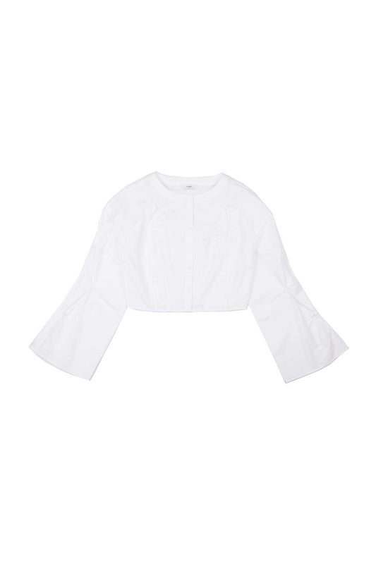 Front view of YIBRI cropped white blouse featuring hand-crocheted floral appliqué, smocked bell sleeves and a clean round neckline — crafted in lightweight cotton poplin.