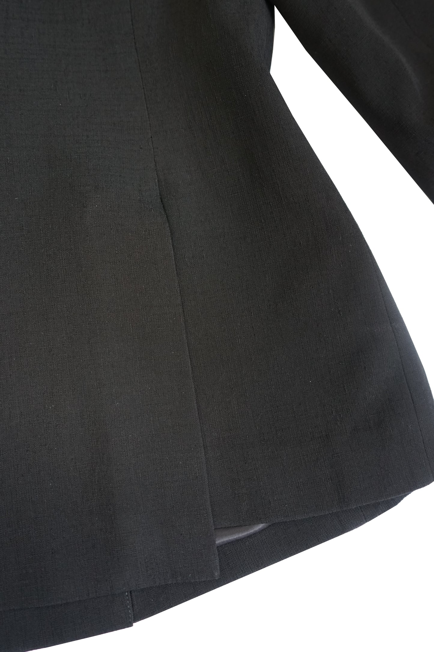 Close-up of the hem and side seam on the YIBRI double-breasted blazer, showing the structured silhouette and clean finishing.