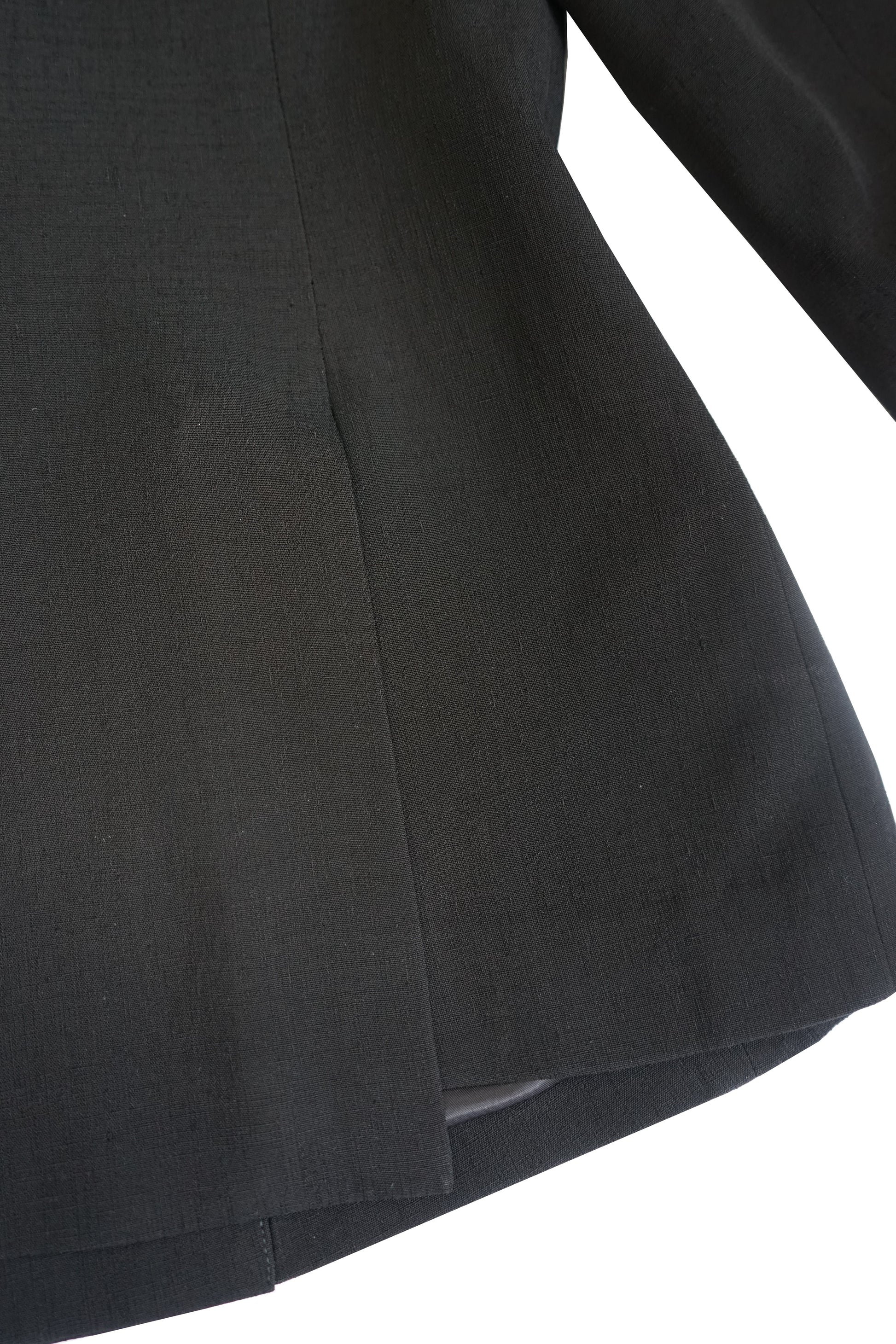 Close-up of the hem and side seam on the YIBRI double-breasted blazer, showing the structured silhouette and clean finishing.