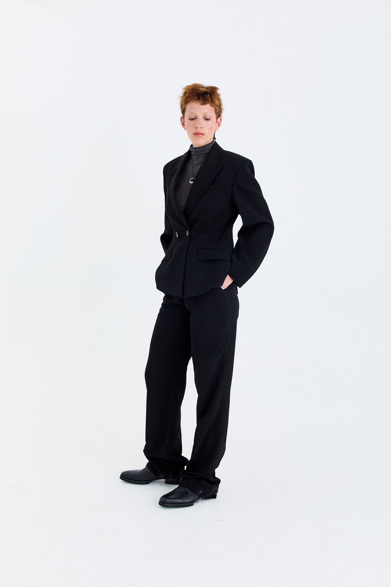 Model wearing the YIBRI double-breasted blazer styled with matching tailored trousers, demonstrating the full proportion and structured fit.