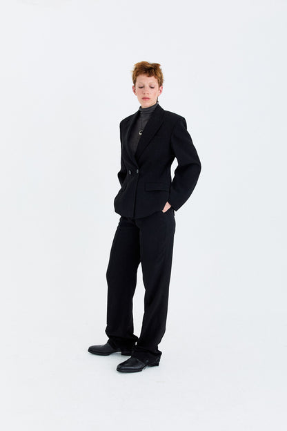 Model wearing the YIBRI double-breasted blazer styled with matching tailored trousers, demonstrating the full proportion and structured fit.