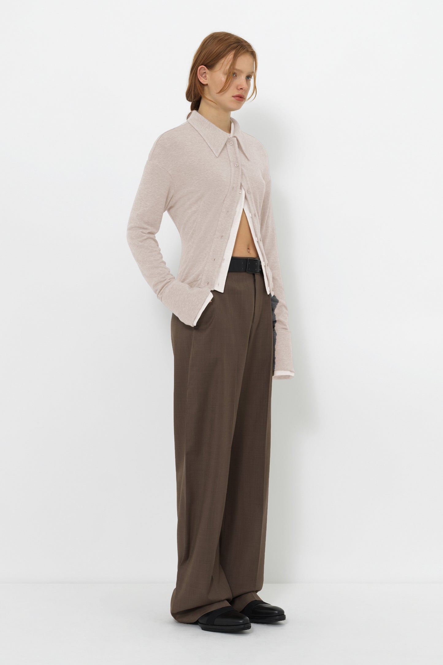 Side view of the YIBRI Fitted Jersey Shirt on model, featuring long sculpted sleeves, slim jersey fit and clean minimal styling.