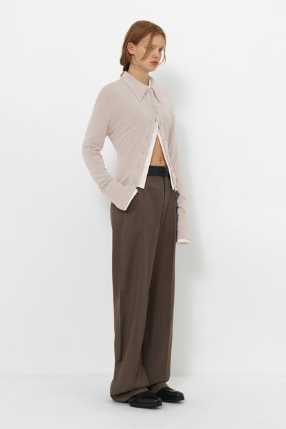 Side view of the YIBRI Fitted Jersey Shirt on model, featuring long sculpted sleeves, slim jersey fit and clean minimal styling.