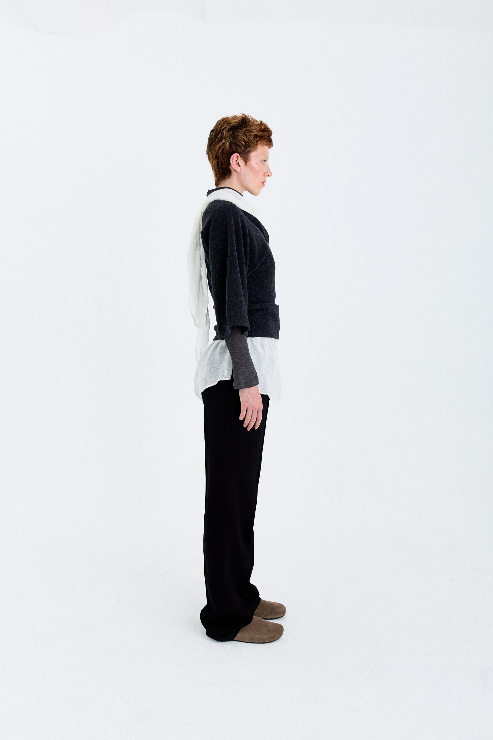 Side view of the YIBRI Fleece Asymmetrical Shoulder Twisted Top, highlighting the sculpted wrap detail and one-shoulder draped shape.