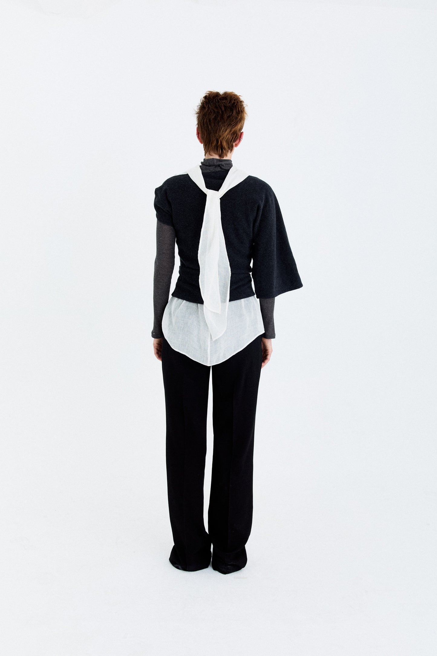 Back model view of the YIBRI Fleece Asymmetrical Shoulder Twisted Top, featuring the twisted wrap construction and clean sculptural fit.