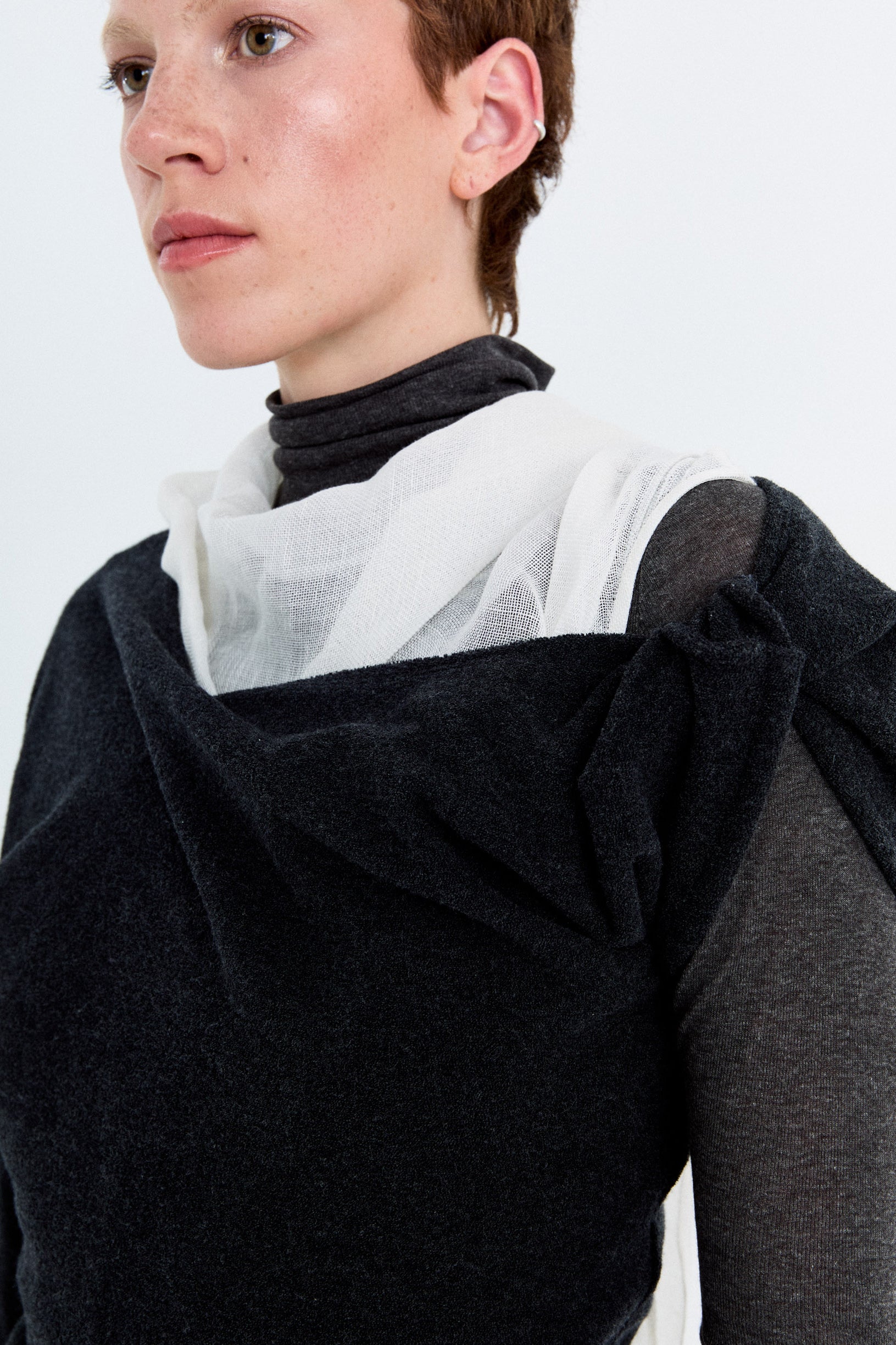 Close-up detail of the YIBRI Fleece Asymmetrical Shoulder Twisted Top, highlighting the gathered twist and plush fleece texture.