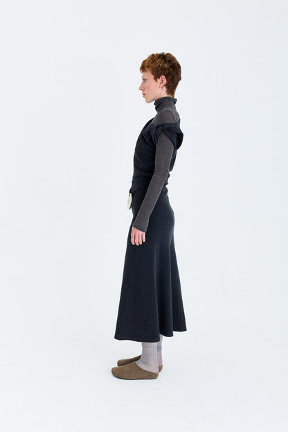 Person wearing a FLEECE ASYMMETRICAL STRUCTURED KNITTED WOOL DRESS with a fitted bodice and flowing skirt on a white background, flannel fabric, textured fabric 