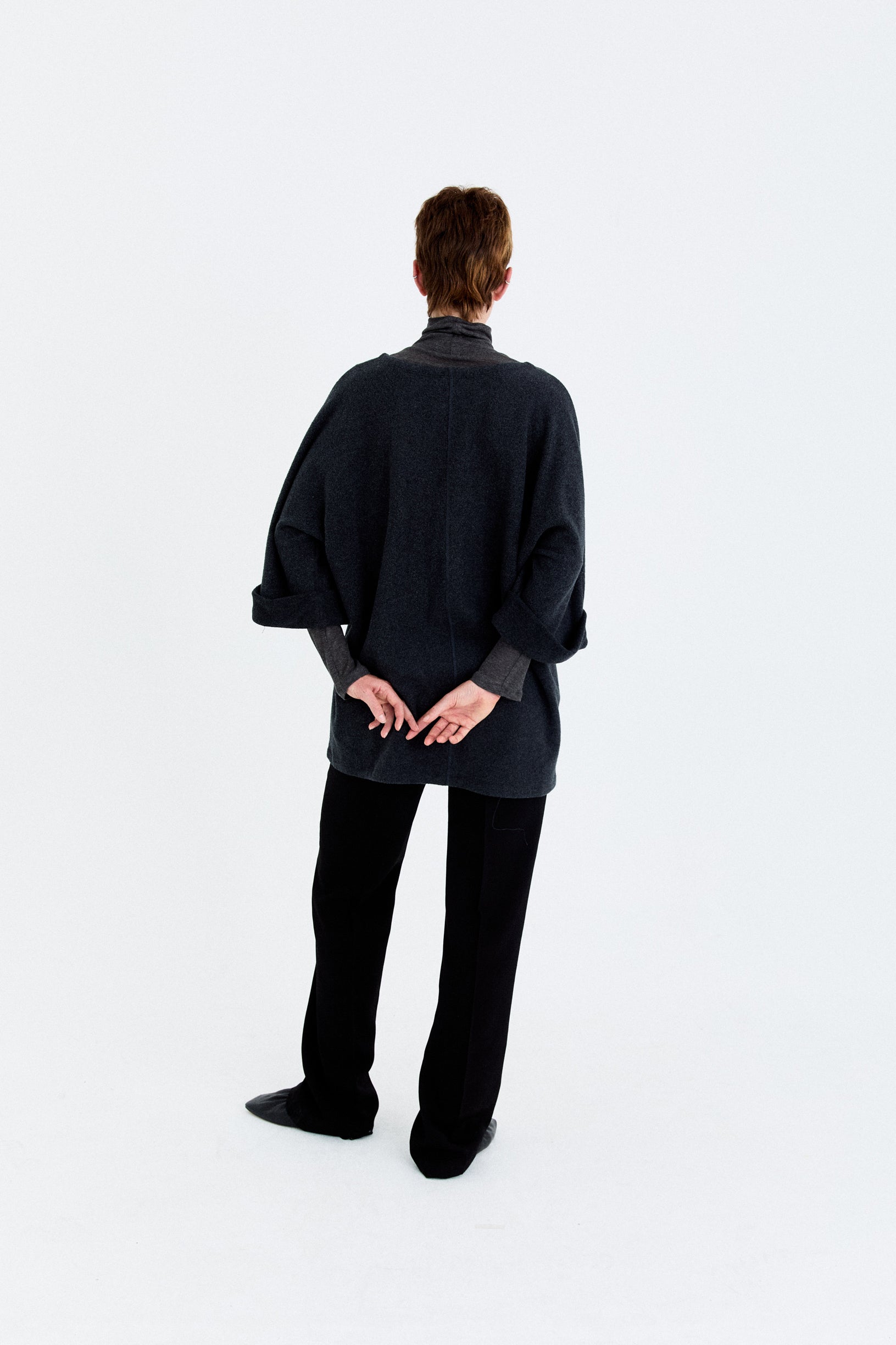 Back model view of the YIBRI Fleece Oversized Roll-Sleeve Top, highlighting the minimalist lines and clean oversized fit.
