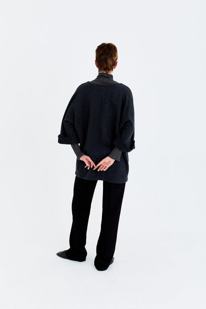 Back model view of the YIBRI Fleece Oversized Roll-Sleeve Top, highlighting the minimalist lines and clean oversized fit.