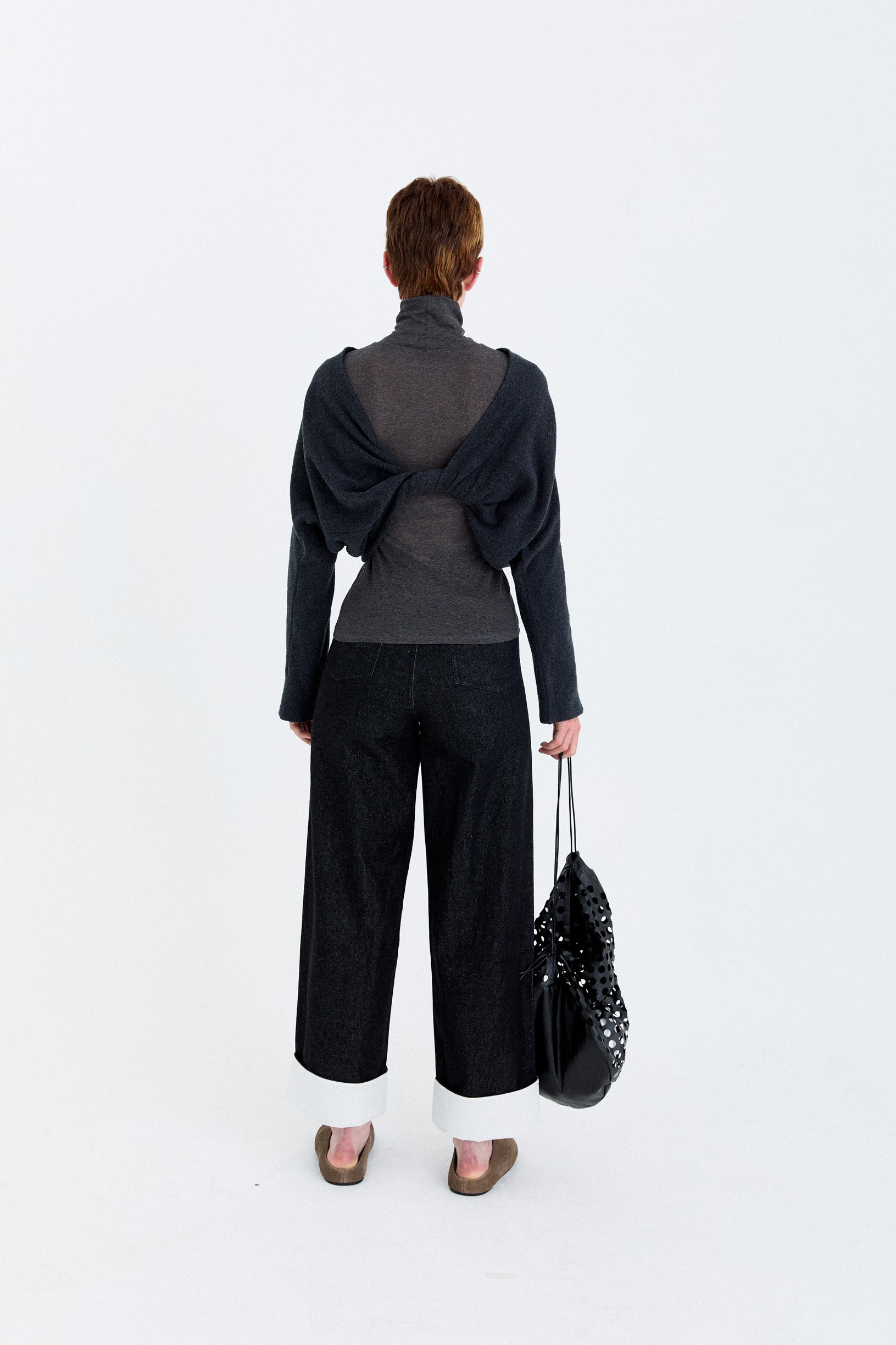 Back model view of the YIBRI Fleece Reversible Twisted Top worn with the twist detailing at the back, revealing the sculptural drape.