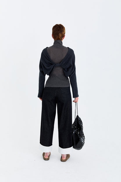 Back model view of the YIBRI Fleece Reversible Twisted Top worn with the twist detailing at the back, revealing the sculptural drape.
