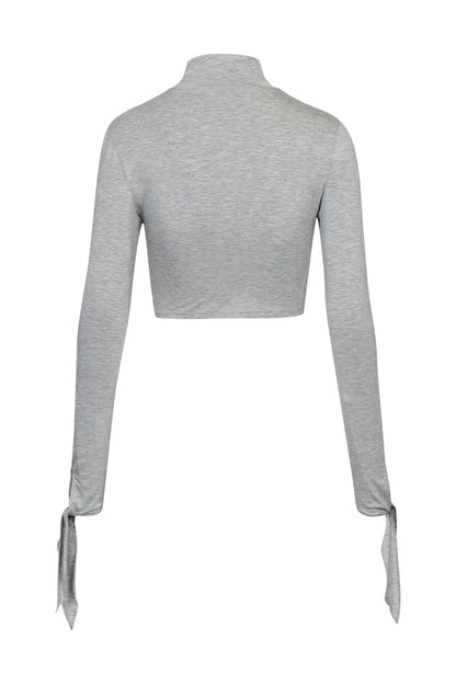 Back view of YIBRI Grey Draped Jersey Crop Top showing clean cropped back, smooth jersey finish and slim long sleeves.