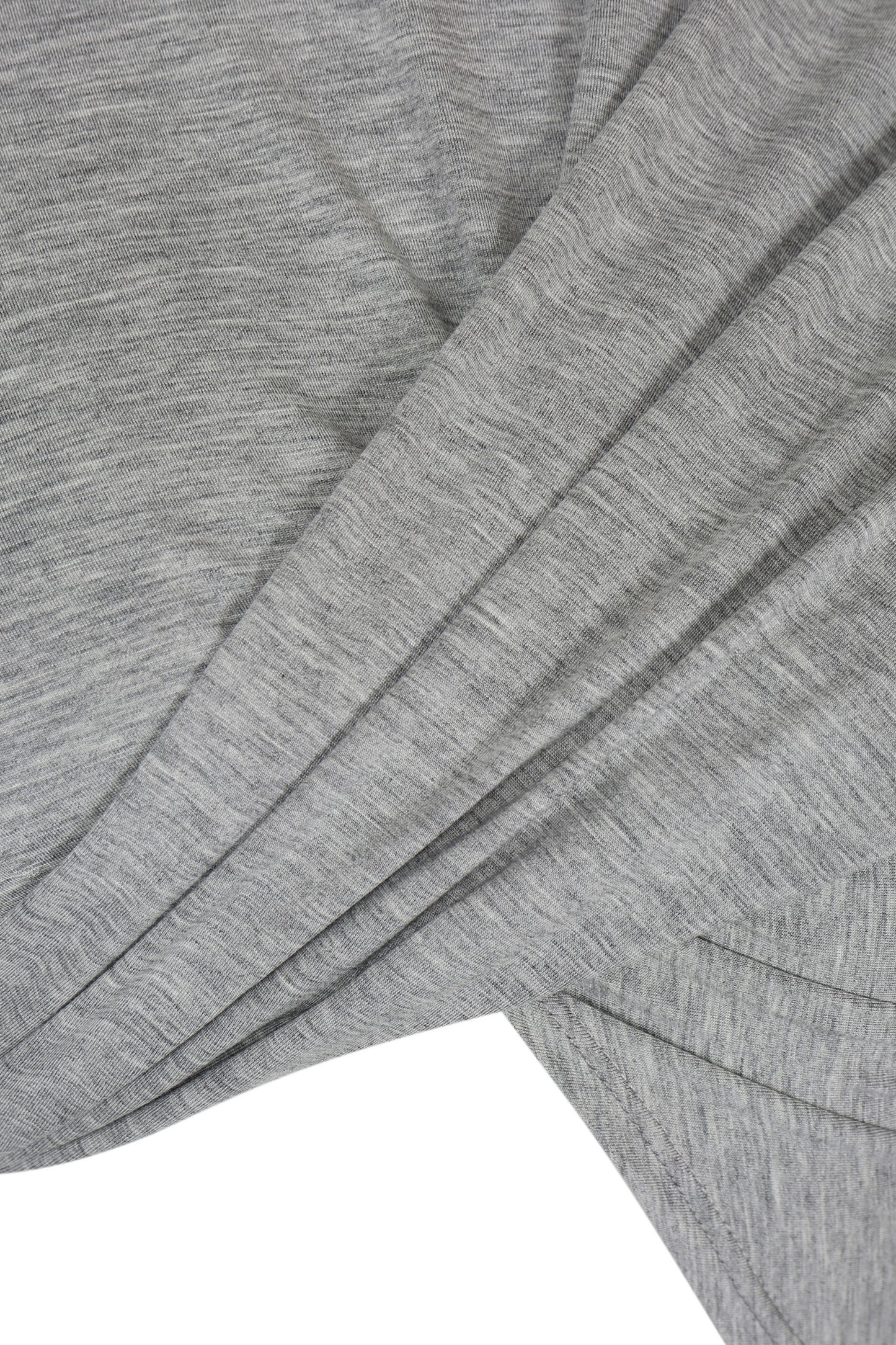 Close-up of YIBRI Grey Draped Jersey Crop Top’s front draped panels, highlighting the soft heather jersey texture and sculptural folds.