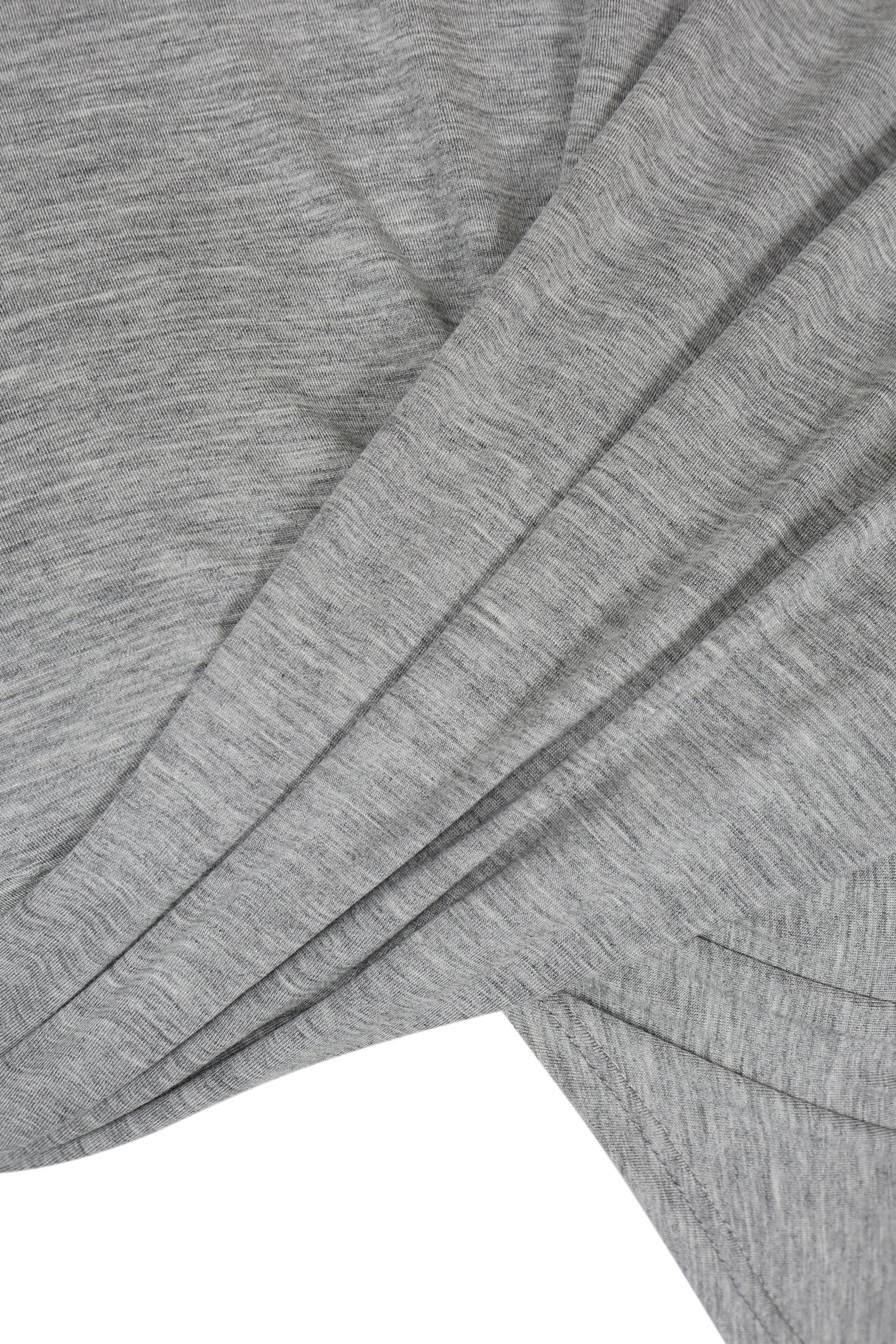 Close-up of YIBRI Grey Draped Jersey Crop Top’s front draped panels, highlighting the soft heather jersey texture and sculptural folds.