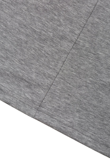 Detail view of the hem and jersey texture on the YIBRI Grey Twisted Long Jersey Sleeve Top, showing the subtle heathered surface.