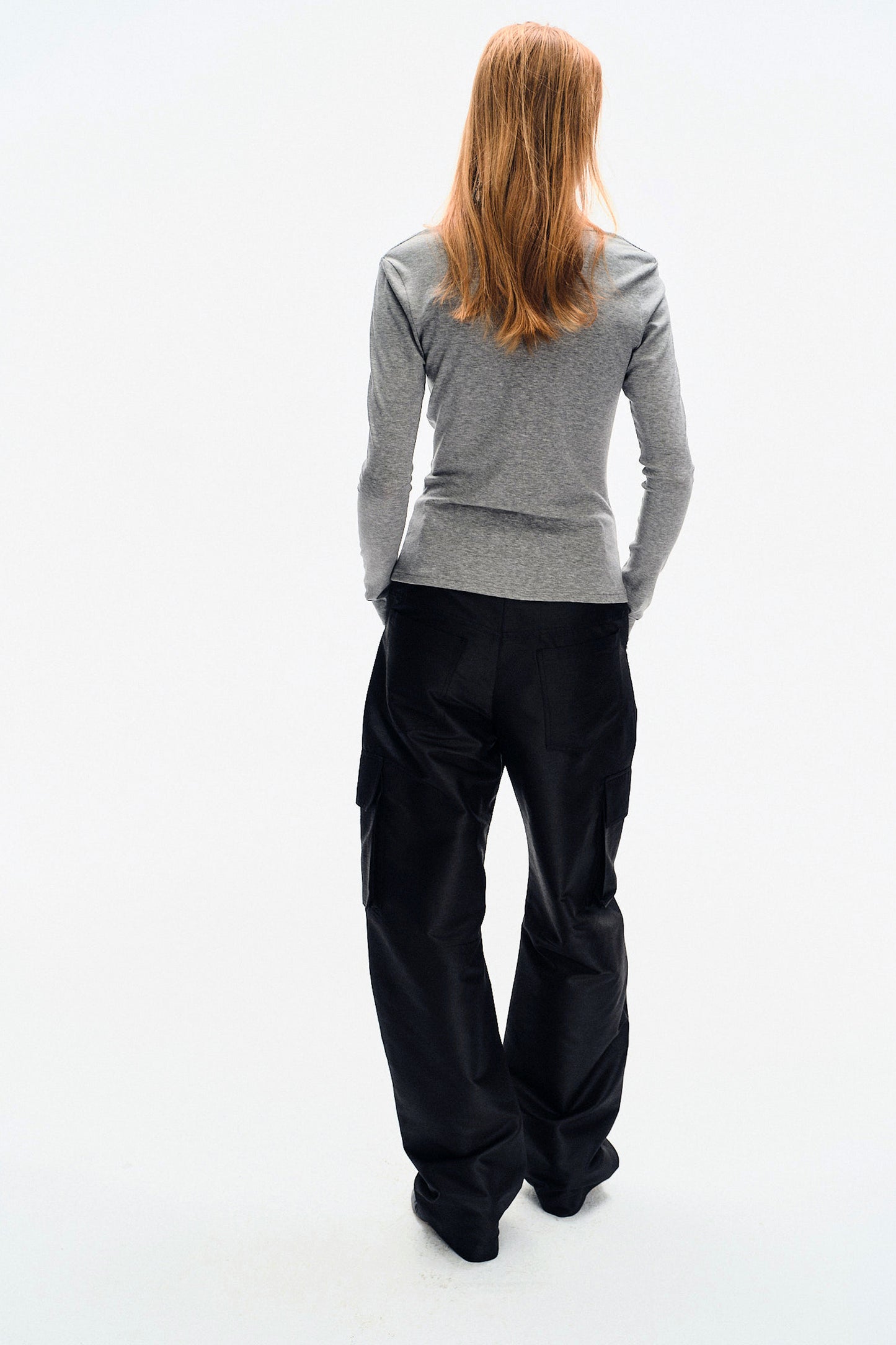 Model back view of the YIBRI Grey Twisted Long Jersey Sleeve Top, highlighting the smooth clean lines of the heather-grey jersey.
