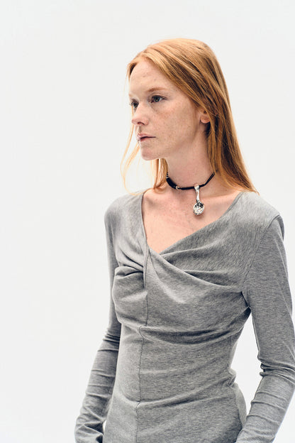 Portrait close-up of the YIBRI Grey Twisted Long Jersey Sleeve Top, showcasing the twisted neckline and soft draped jersey.