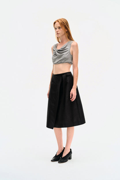 Three-quarter view of model in the YIBRI Heather Grey Twisted Front Jersey Crop Top showing the natural drape and sculpted twist front.