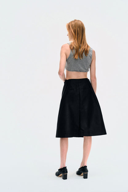 Back view of model in the YIBRI Heather Grey Twisted Front Jersey Crop Top, revealing clean back hem and fitted silhouette.