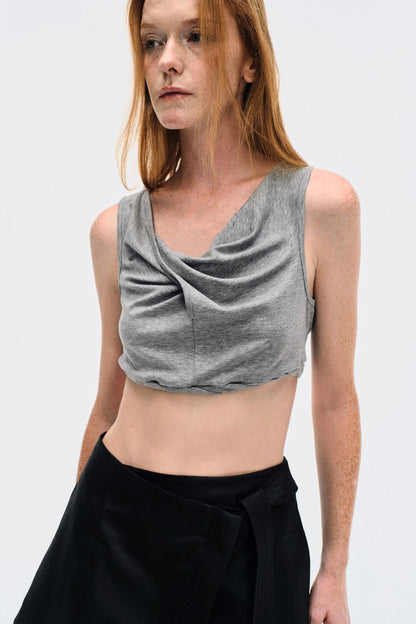 Close-up on model wearing the YIBRI Heather Grey Twisted Front Jersey Crop Top, focusing on the draped neckline and soft jersey texture.