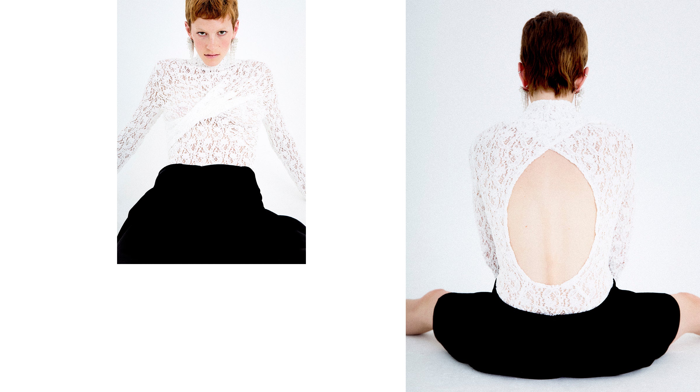 Woman wearing a white lace top and black asymmetrical twisted skirt sitting on a white background.