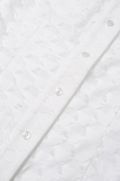 Detail of the button placket on the YIBRI Jacquard Fringe Shirt, highlighting tonal buttons and the dimensional woven texture.