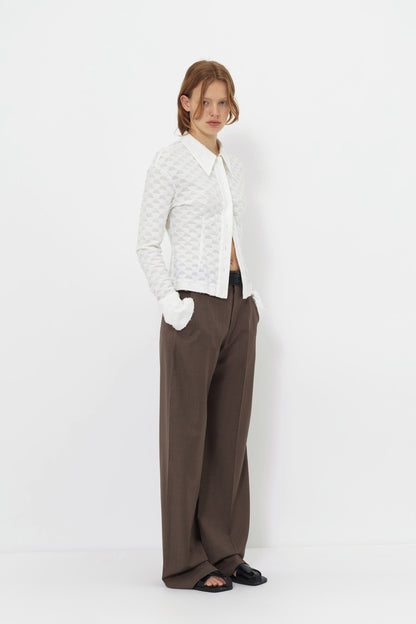 Three-quarter view of the YIBRI Jacquard Fringe Shirt styled minimally, showing texture, fit, and tonal buttons.