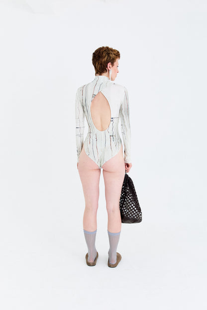 Back model view of the YIBRI Printed Stretchy Open-Back Bodysuit featuring the open oval cut-out and soft gathering at the twist seam.