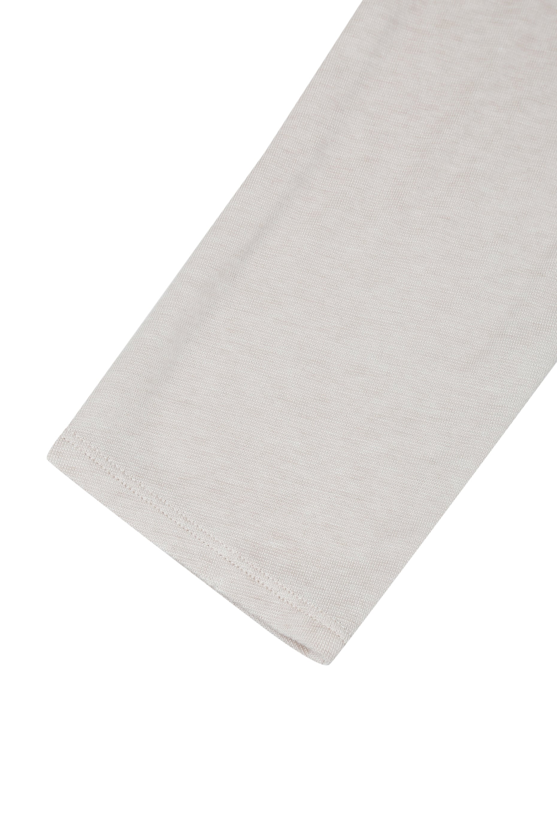 Detail of the sleeve hem on the YIBRI Reversible Cropped Cardigan, highlighting clean finishing, lightweight jersey texture, and minimal construction.