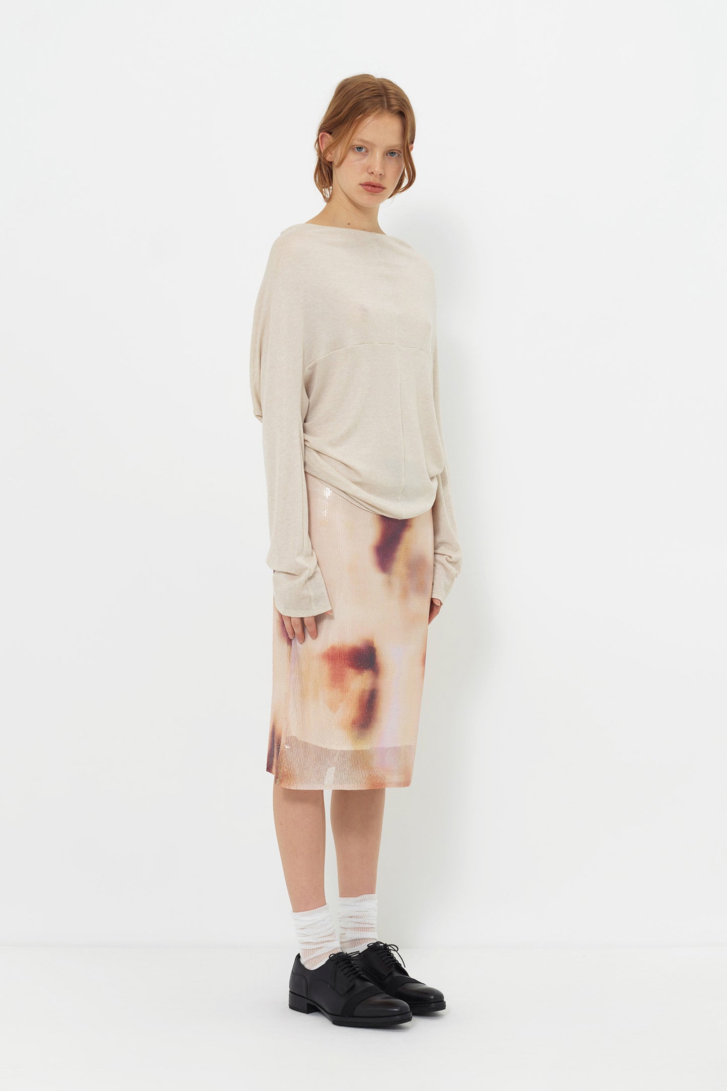 Lookbook side view of the YIBRI Reversible Cropped Cardigan, showing the slouchy silhouette, soft jersey folds and effortless styling.