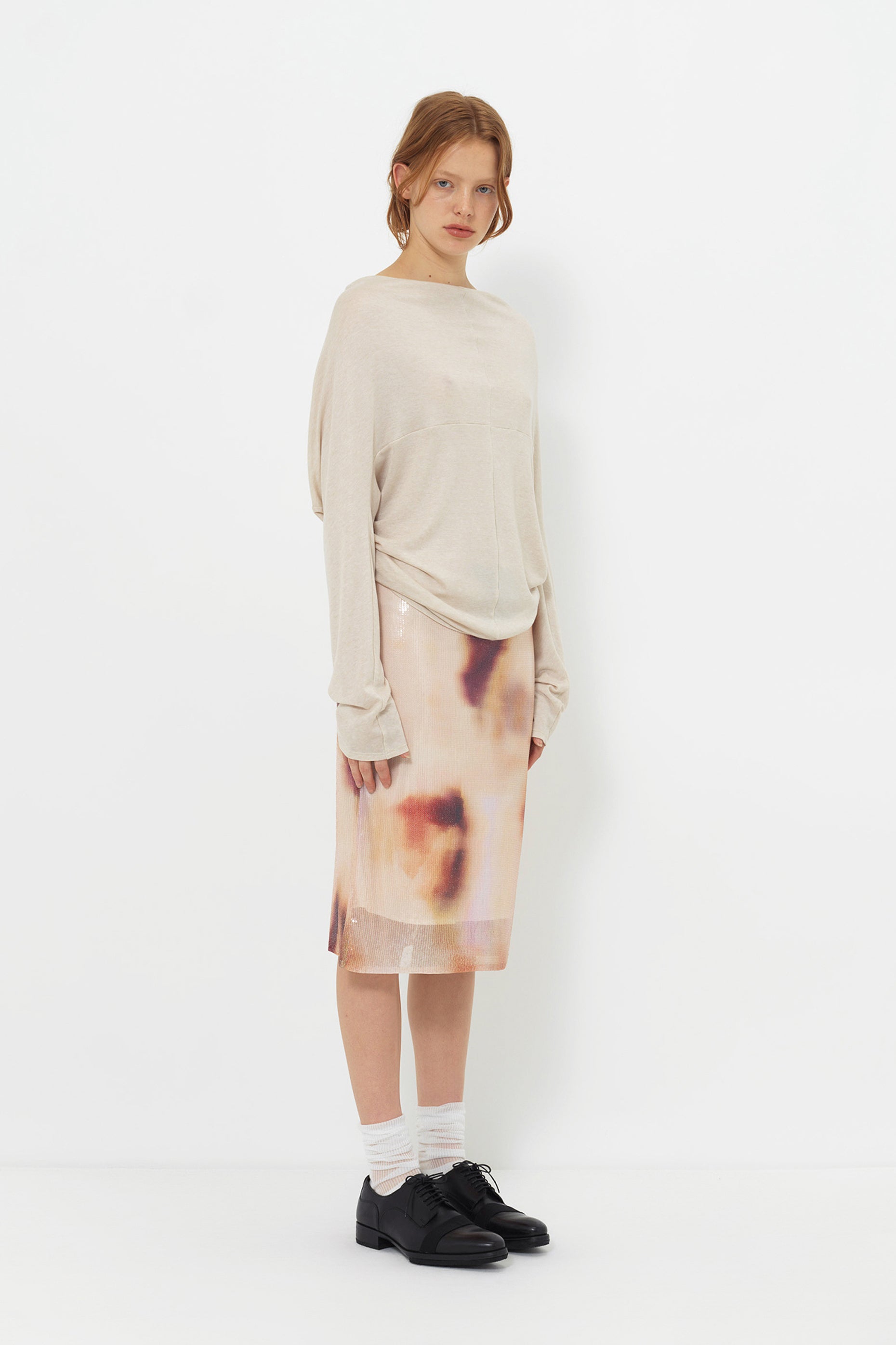 Lookbook side view of the YIBRI Reversible Cropped Cardigan, showing the slouchy silhouette, soft jersey folds and effortless styling.