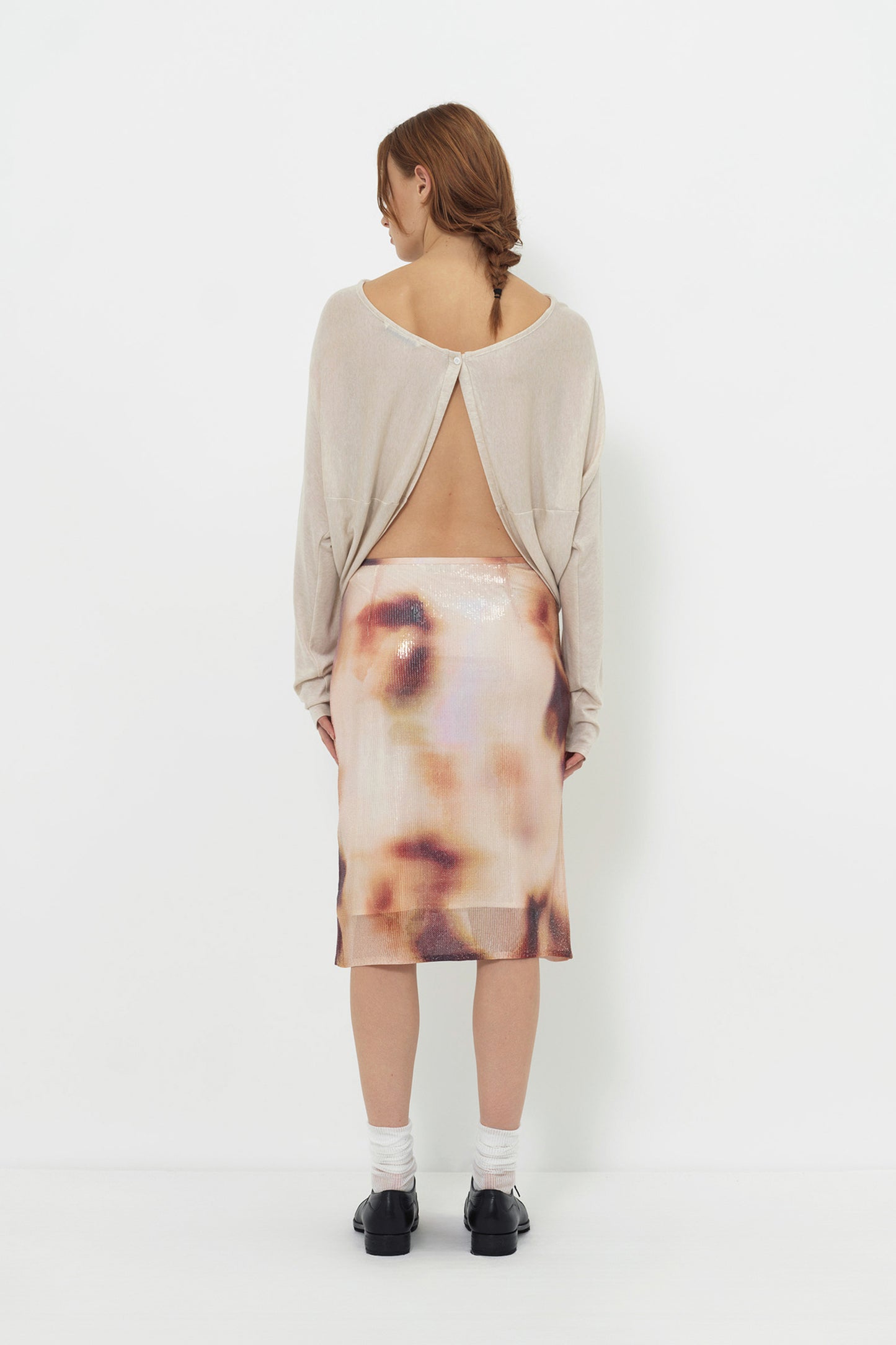 Lookbook back view of the YIBRI Reversible Cropped Cardigan worn open-back style, revealing the button closure at the top and draped open panels.