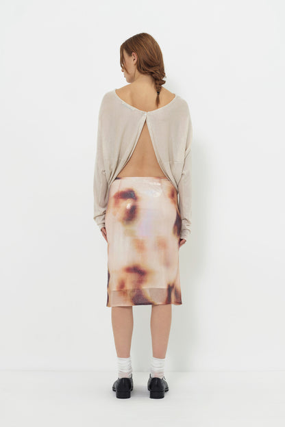 Lookbook back view of the YIBRI Reversible Cropped Cardigan worn open-back style, revealing the button closure at the top and draped open panels.