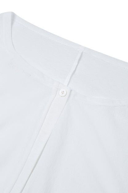 Close-up of the neckline on the YIBRI Reversible Cropped Cardigan highlighting soft jersey texture and refined stitching.