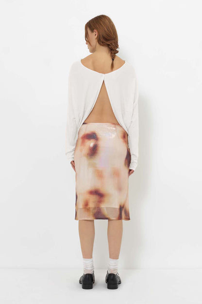 Back view of the YIBRI Reversible Cropped Cardigan styled open with the single-button closure revealing an elegant open-back silhouette.