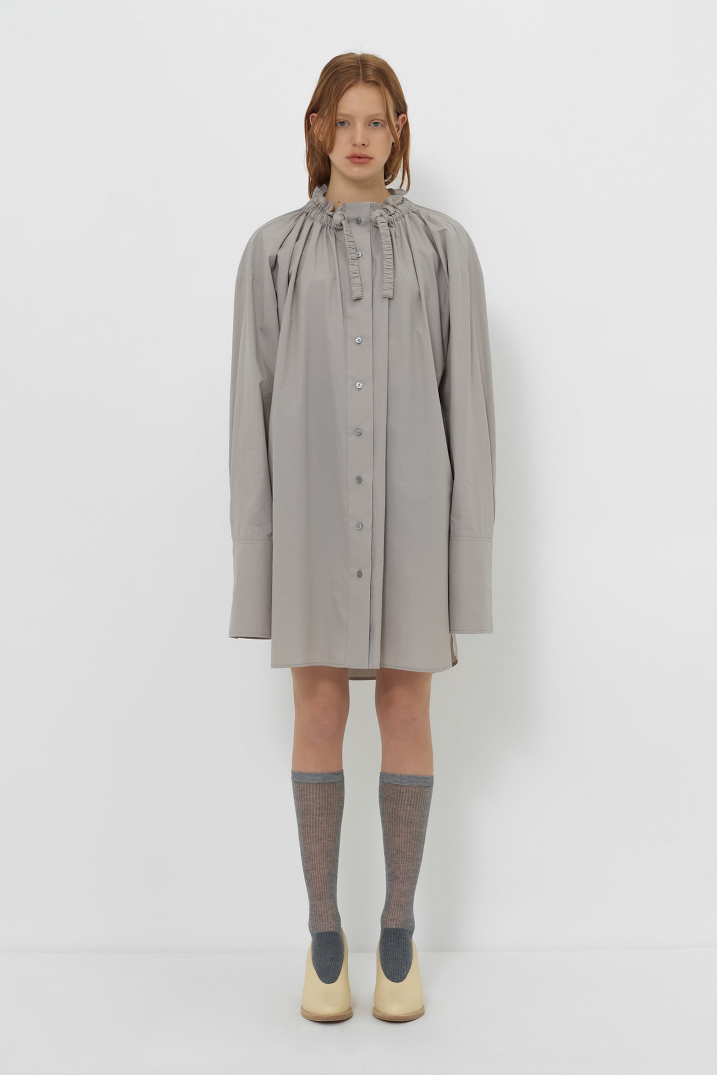 Model wearing YIBRI Ruched Collar Long Shirt in grey with oversized silhouette, gathered neckline and long cuffs — understated quiet luxury styling.