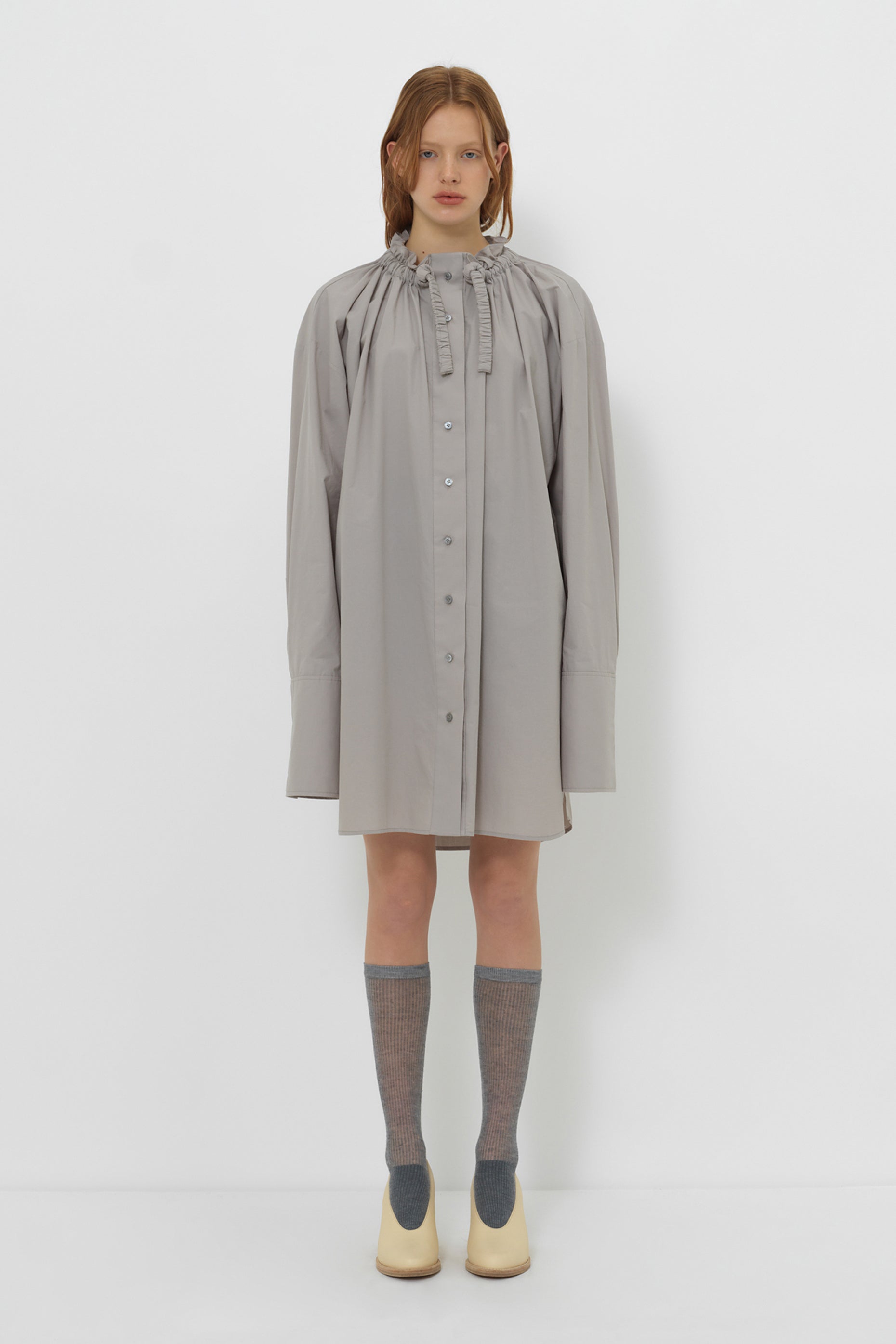 Model wearing YIBRI Ruched Collar Long Shirt in grey with oversized silhouette, gathered neckline and long cuffs — understated quiet luxury styling.