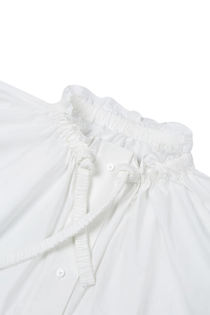 Close-up of white washed cotton fabric and button details on the YIBRI Ruched Collar Short Shirt, highlighting natural fibre texture and refined craftsmanship.