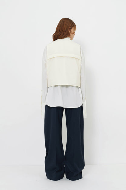 Back angle of model wearing the YIBRI Ruched Collar Short Shirt in white washed cotton, featuring natural fibre texture and soft quiet luxury movement.