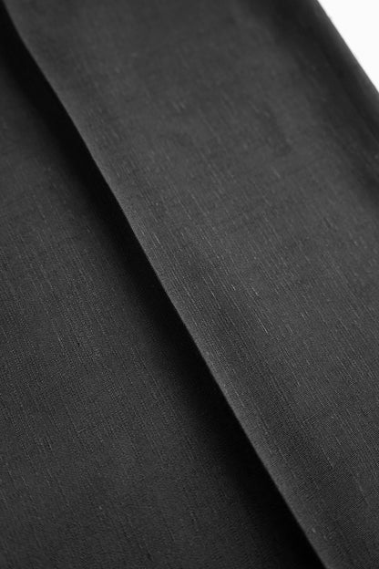 Close-up of the black suiting fabric used in the YIBRI Straight-Leg Suit Trousers, highlighting its subtle texture and premium weave.