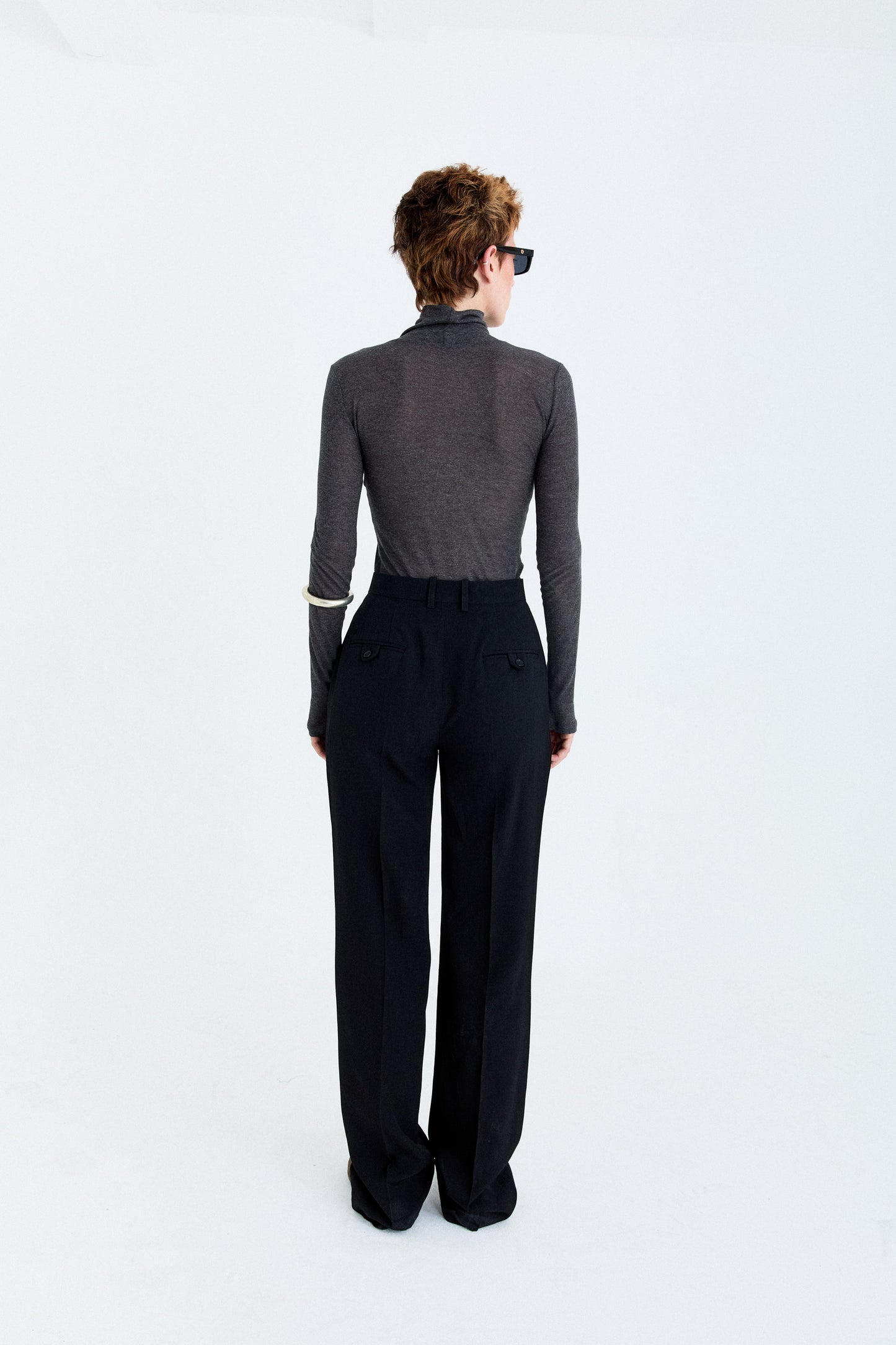 Back view of the YIBRI Straight-Leg Suit Trousers on model, highlighting the tailored waistband and welt pocket detailing.