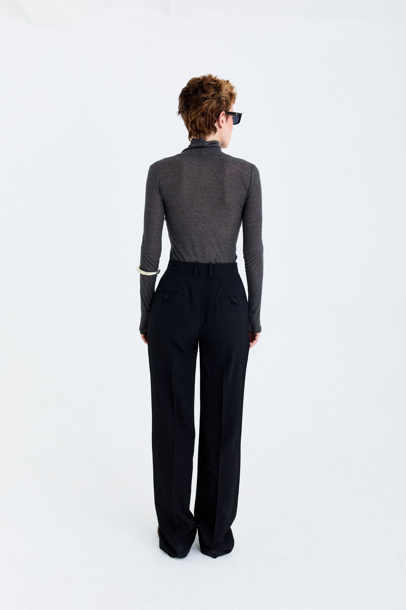 Back view of the YIBRI Straight-Leg Suit Trousers on model, highlighting the tailored waistband and welt pocket detailing.