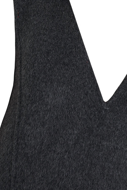 Close-up of a textured long hair double face wool fabric with a V-shaped cutout on a white background