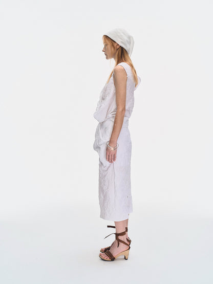 Side view of the YIBRI White Crinkled Texture Sleeveless Top showing the sculptural folded volume and modern sleeveless silhouette.