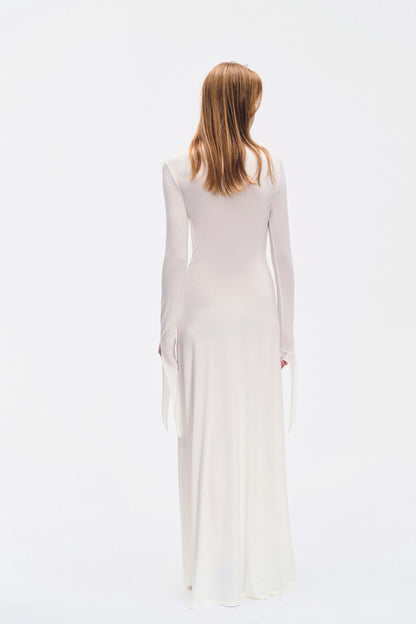 Back view of YIBRI ivory draped long-sleeve maxi dress showing clean minimal silhouette and extended cuff ties
